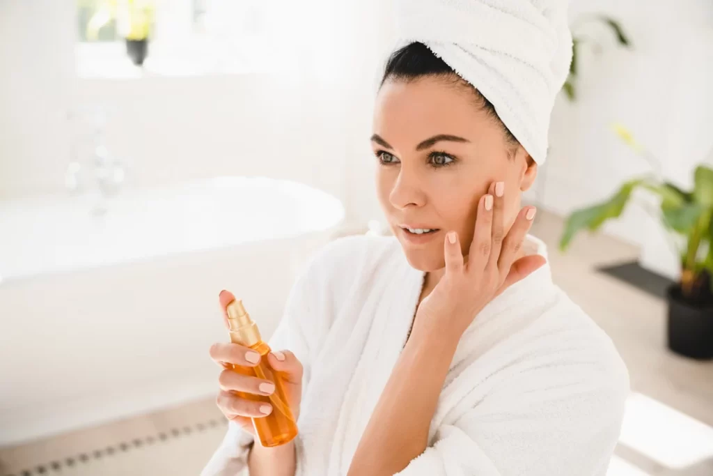 mature woman in a bathrobe applying beauty rejuvenate.