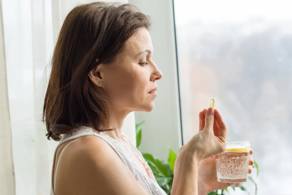 Woman intaking Thorne liver cleanse supplements to solve her liver problem.