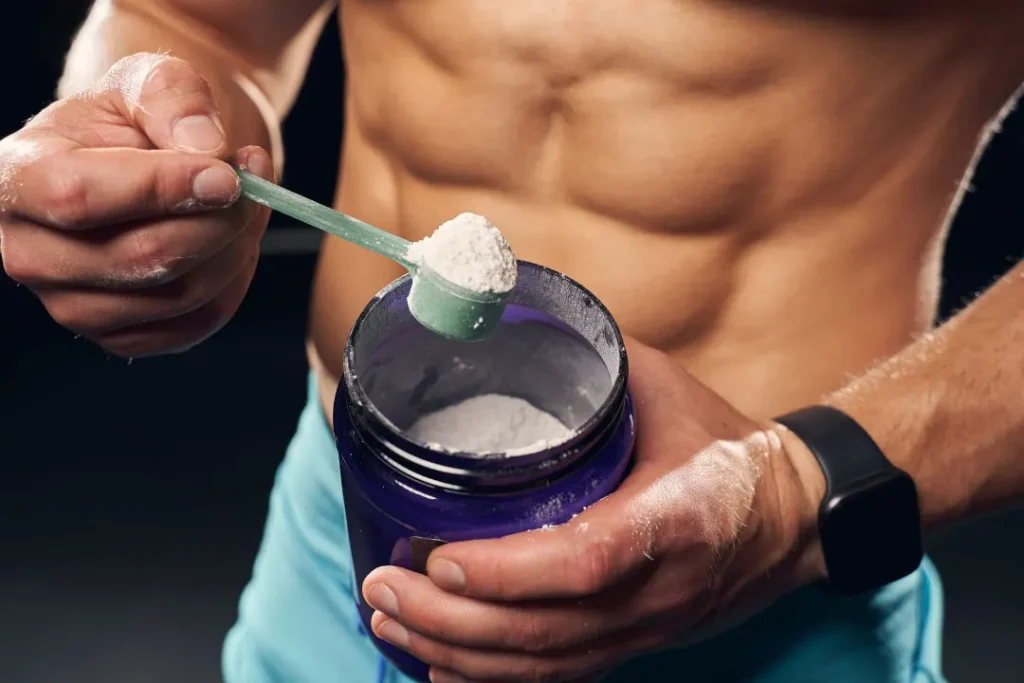 man holding a container with protein powder