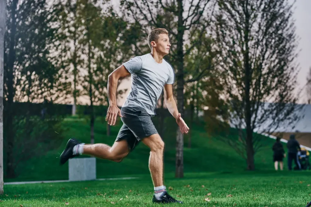 A boy running in a park.