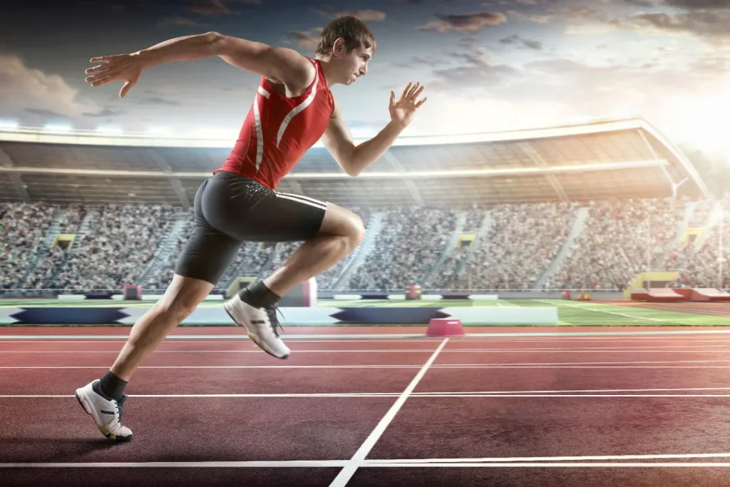 A boy runnig in a stadium.