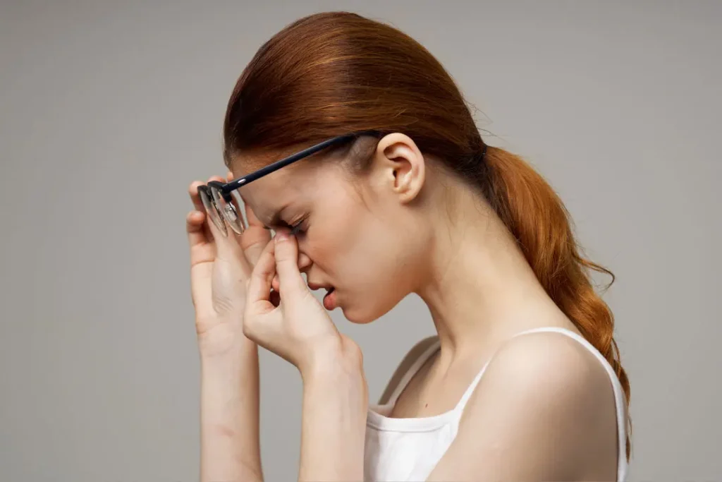 A girl having pain in his eyes.