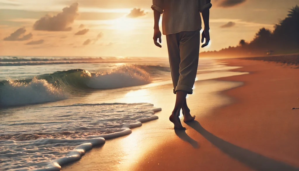 A peaceful coastal scene of a person walking barefoot on a sandy beach, with gentle ocean waves and a golden sunset in the background. The individual appears calm and reflective, enjoying the soothing nature of the environment. The sky is painted in warm pastel hues, enhancing the tranquility of the moment.