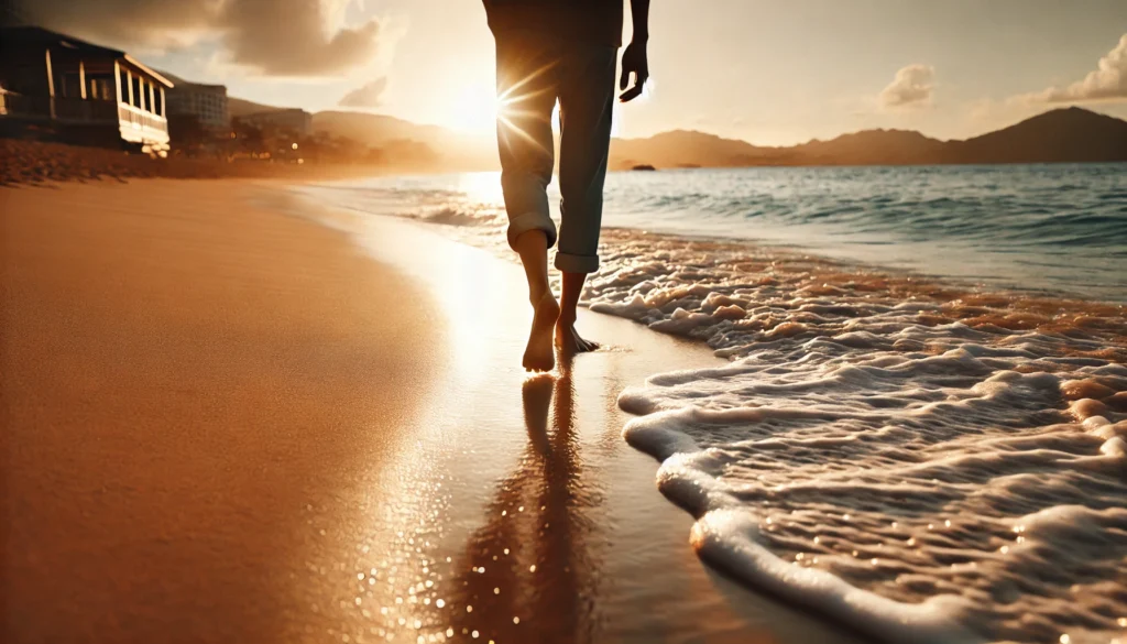 A tranquil beach setting with a person walking barefoot along the shoreline, as gentle waves wash over the sand, creating a calming and meditative environment that promotes relaxation and mental well-being.
